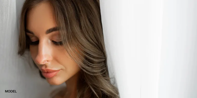 Woman with brown hair looking downward